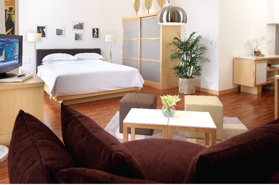 King bed & sitting area in a room at Federal Hotels