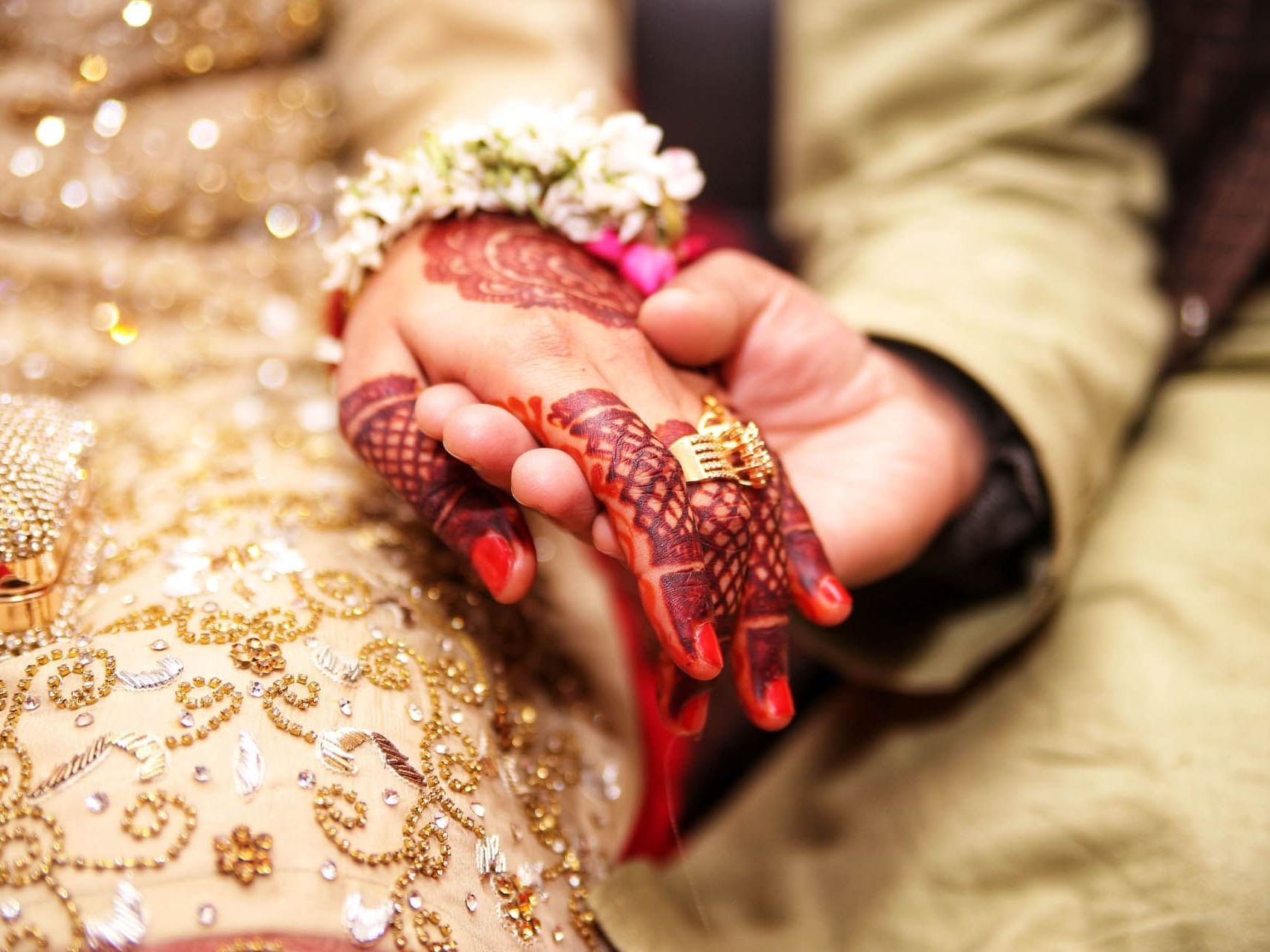 Close-up of Groom holding the Brides hand, featuring the traditional Indian wedding at Saujana Hotel Kuala Lumpur