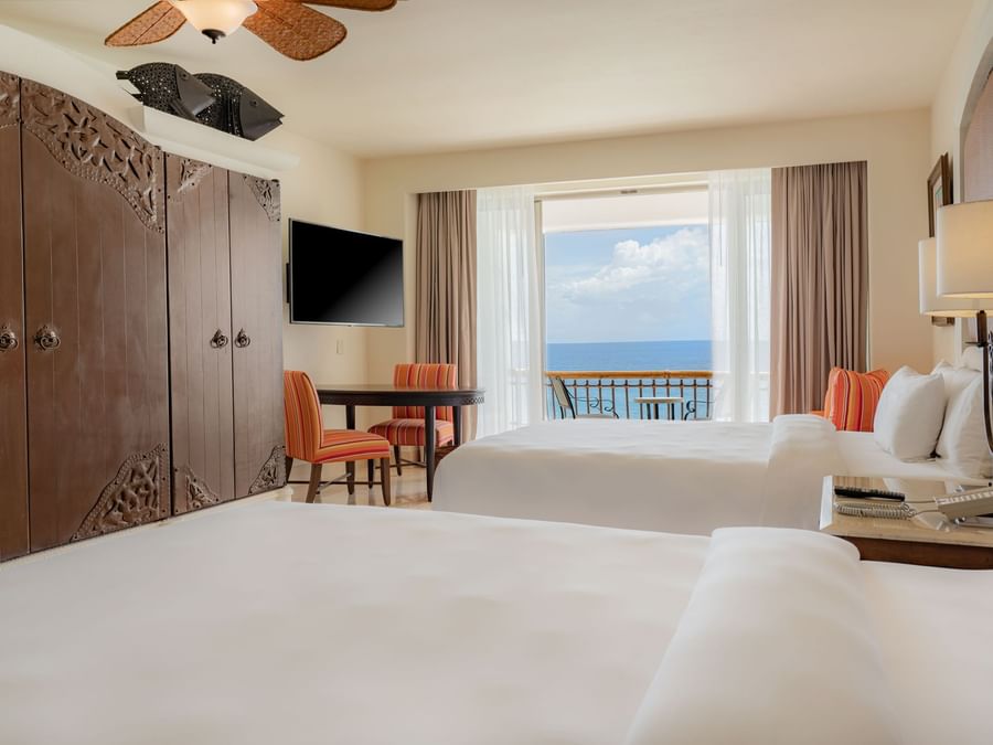 Two Double beds with wooden closet and a private balcony in Junior Suite Ocean View Double at Marquis Los Cabos Resort