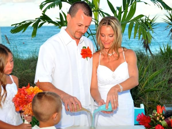 Bride and Groom pouring drinks at Windsong Resort On The Reef