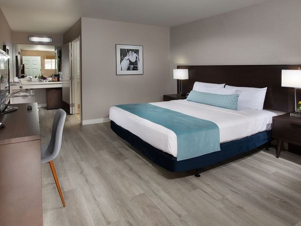 Room with bed, desk, chair, and bathroom