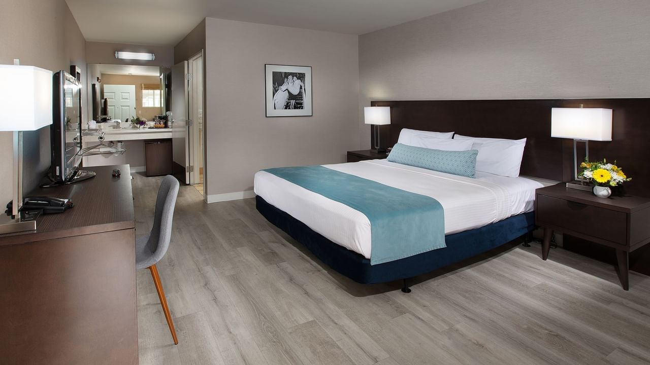 Room with bed, desk, chair, and bathroom