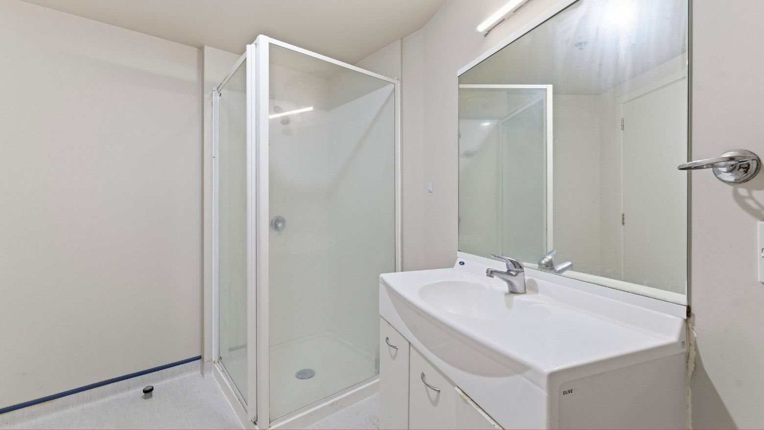 Clean bathroom with shower stall and sink at UniLodge Stafford House.