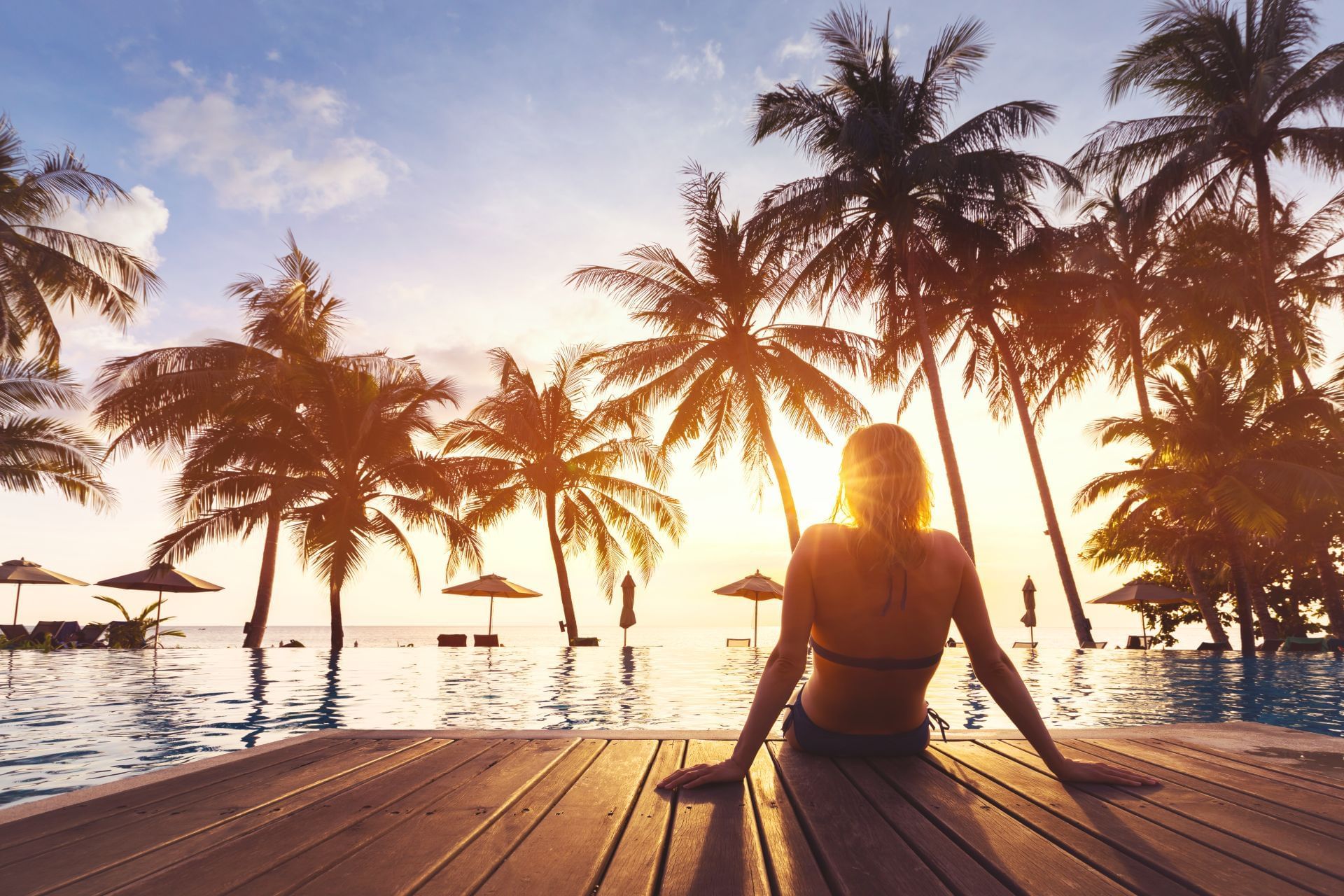 A woman siting near the pool at Sunseeker Resort