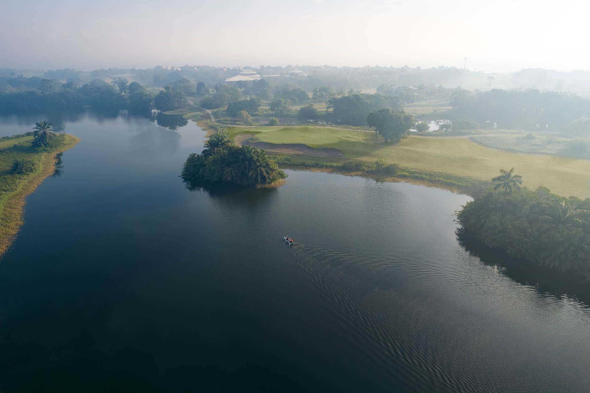 Aerial view of a narrow river through lush greenery near Indura Beach & Golf Resort