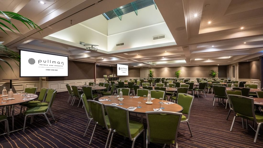 Banquet set-up with projector screens in Ibis Room at Pullman Sydney Hyde Park