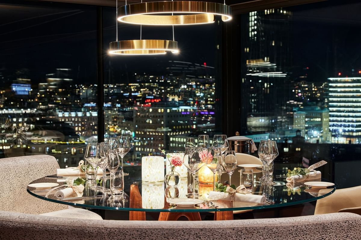 Dukat bord på View Skybar & Restaurant på Hotel Riverton med kvällsutsikt över Göteborgs stadssiluett