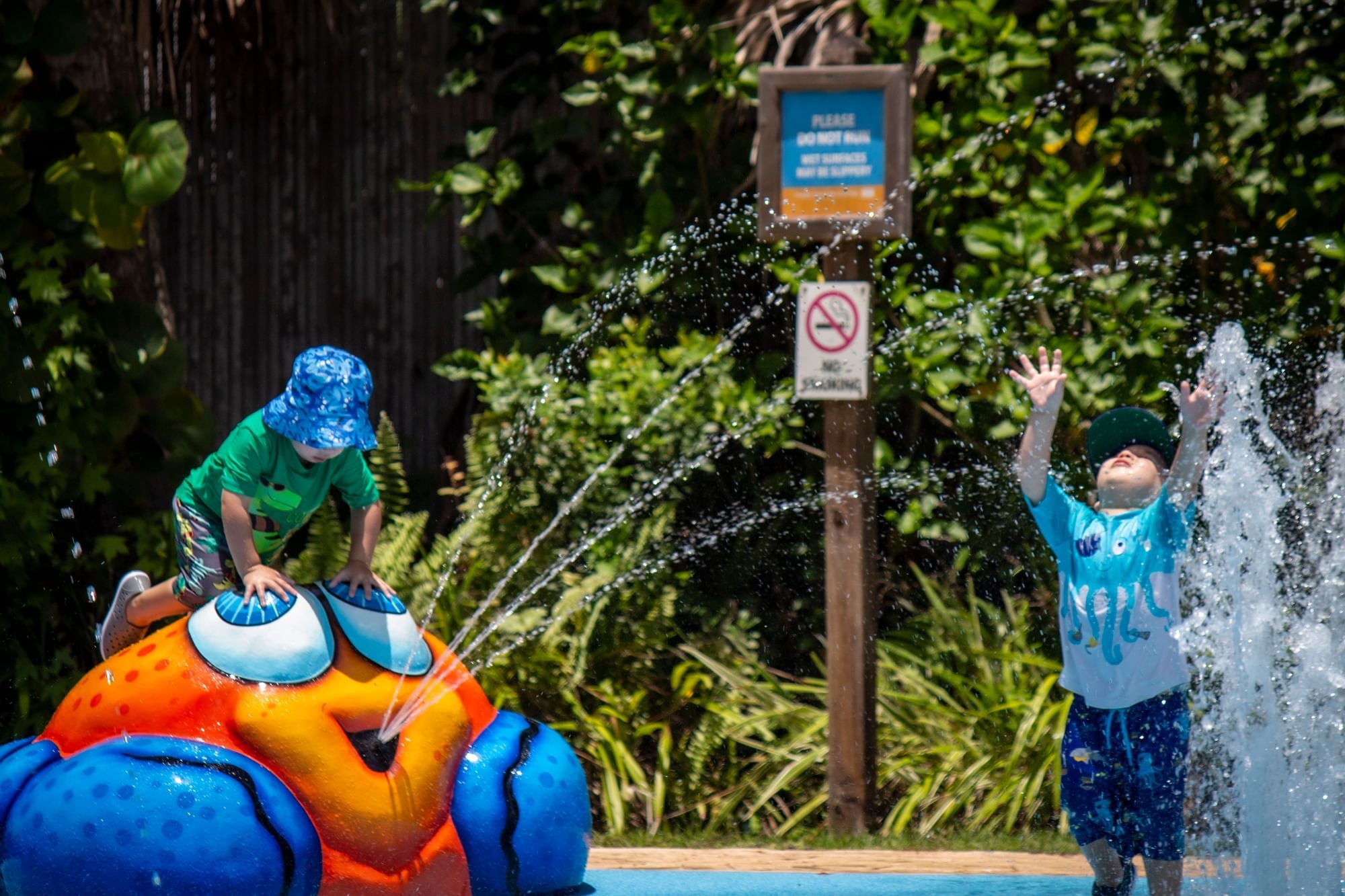 Two children playing in the splash pad at the Central Florida Zoo. 