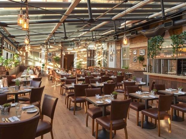 Interior of a restaurant with set tables and modern lighting featuring Dinner, Bed and Breakfast offer at The Milner York