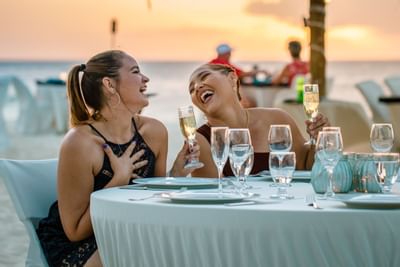 2 Ladies enjoying drinks by the beach at Amsterdam Manor Resort