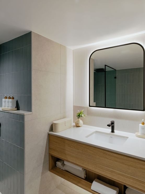 Coastal Two Bedroom Suite at Elysium Manly with toiletries by a vessel sink, a top choice for Manly accommodation