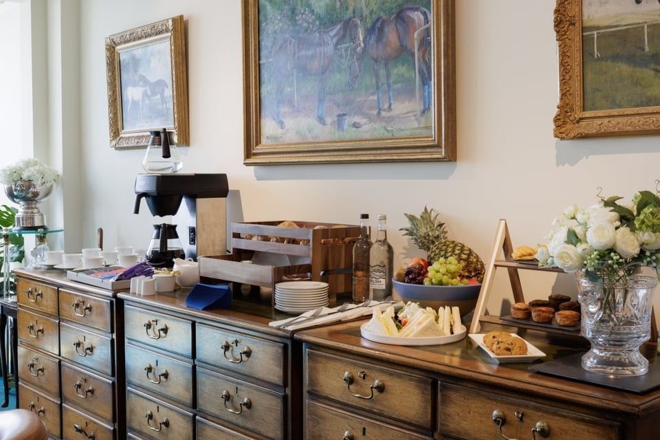 Breakfast buffet spread with fruit & pastries on tables at Polo Club Hotel, highlighting fine dining in Warwickshire