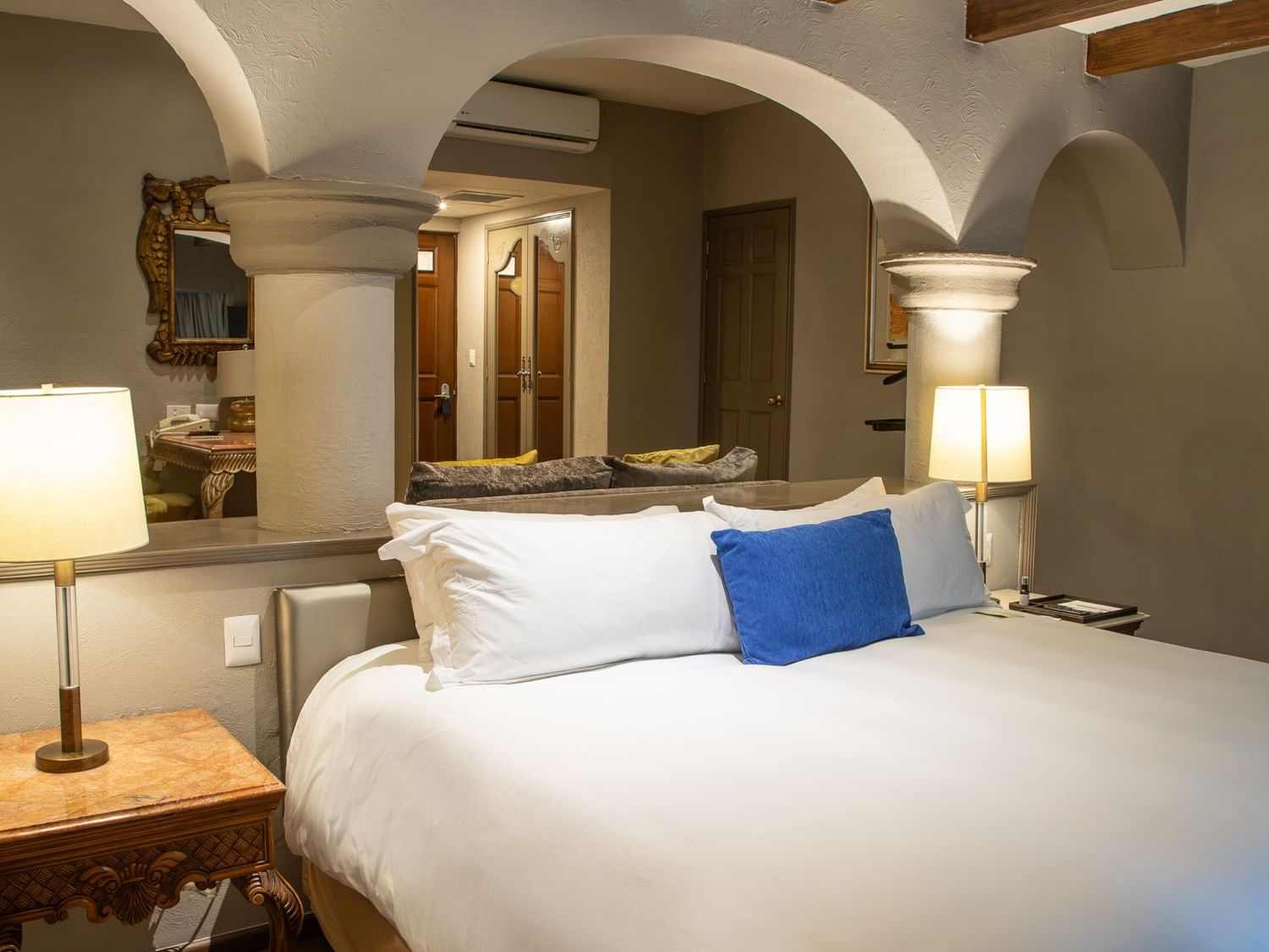 Master Suite King con cama king, arcos coloniales y lámparas de mesa en Quinta Real Guadalajara