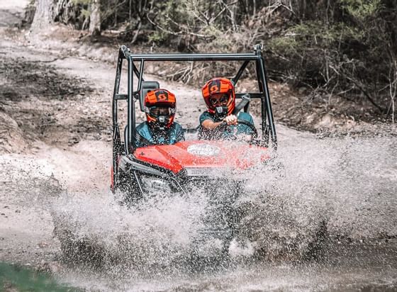 People on an ATV experience in a trail near Freycinet Lodge