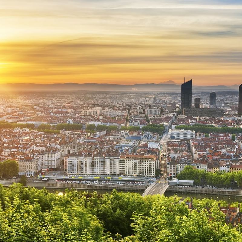 Panoramic view of Lyon, showcasing the cityscape, river, and greenery near Warwick Hotels and Resorts
