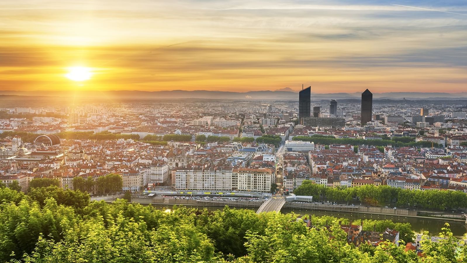 Panoramic view of Lyon, showcasing the cityscape, river, and greenery near Warwick Hotels and Resorts