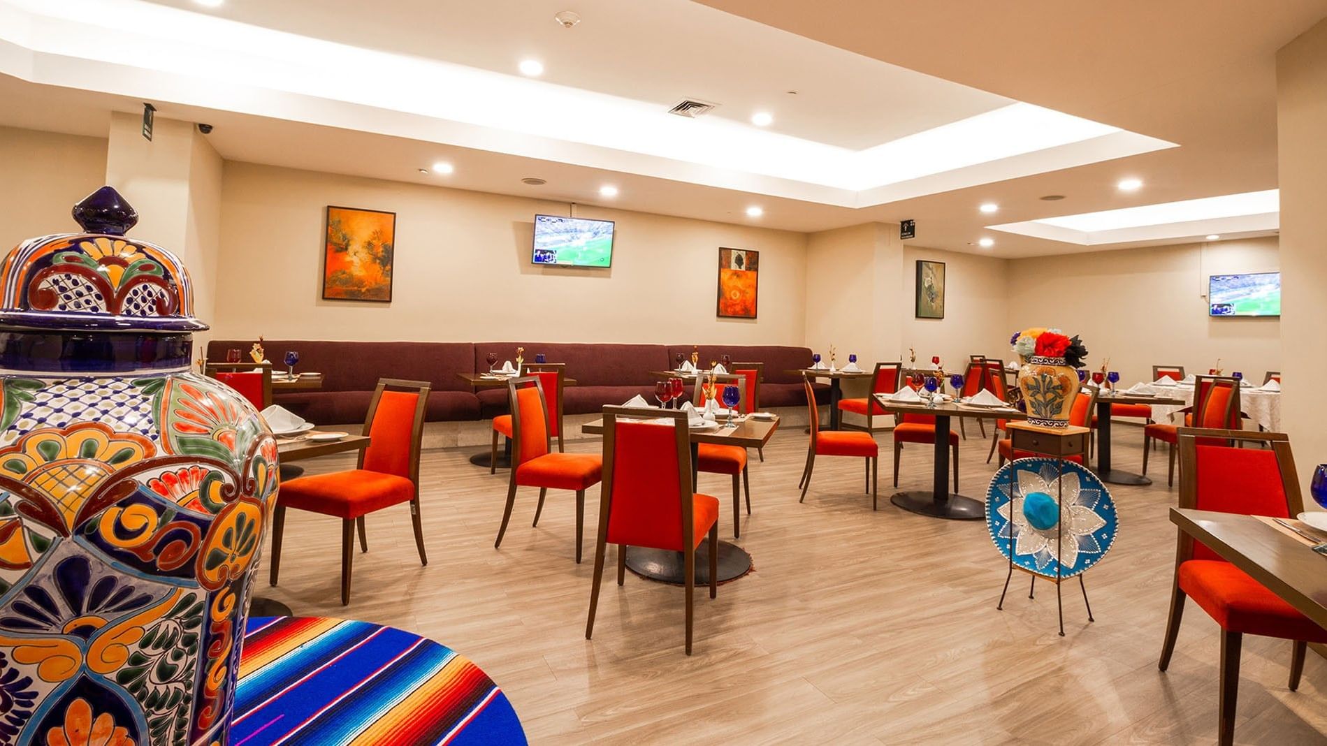 Dining area with tables and chairs at Cualli Restaurant in Camino Real Aeropuerto Mexico, Ciudad de Mexico.