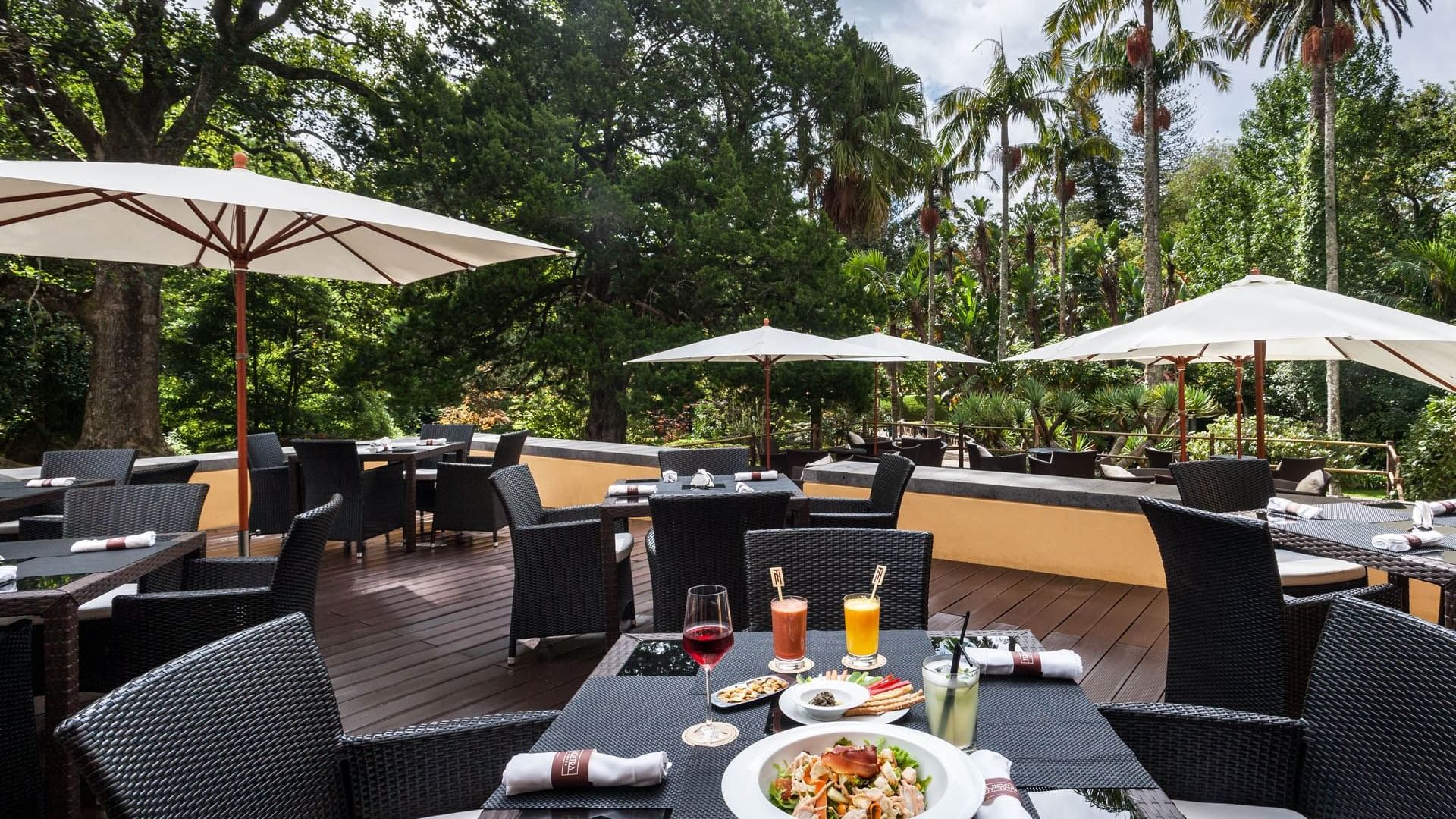 Meals served on a table in The Gardener's outdoor dining area at Terra Nostra Garden Hotel