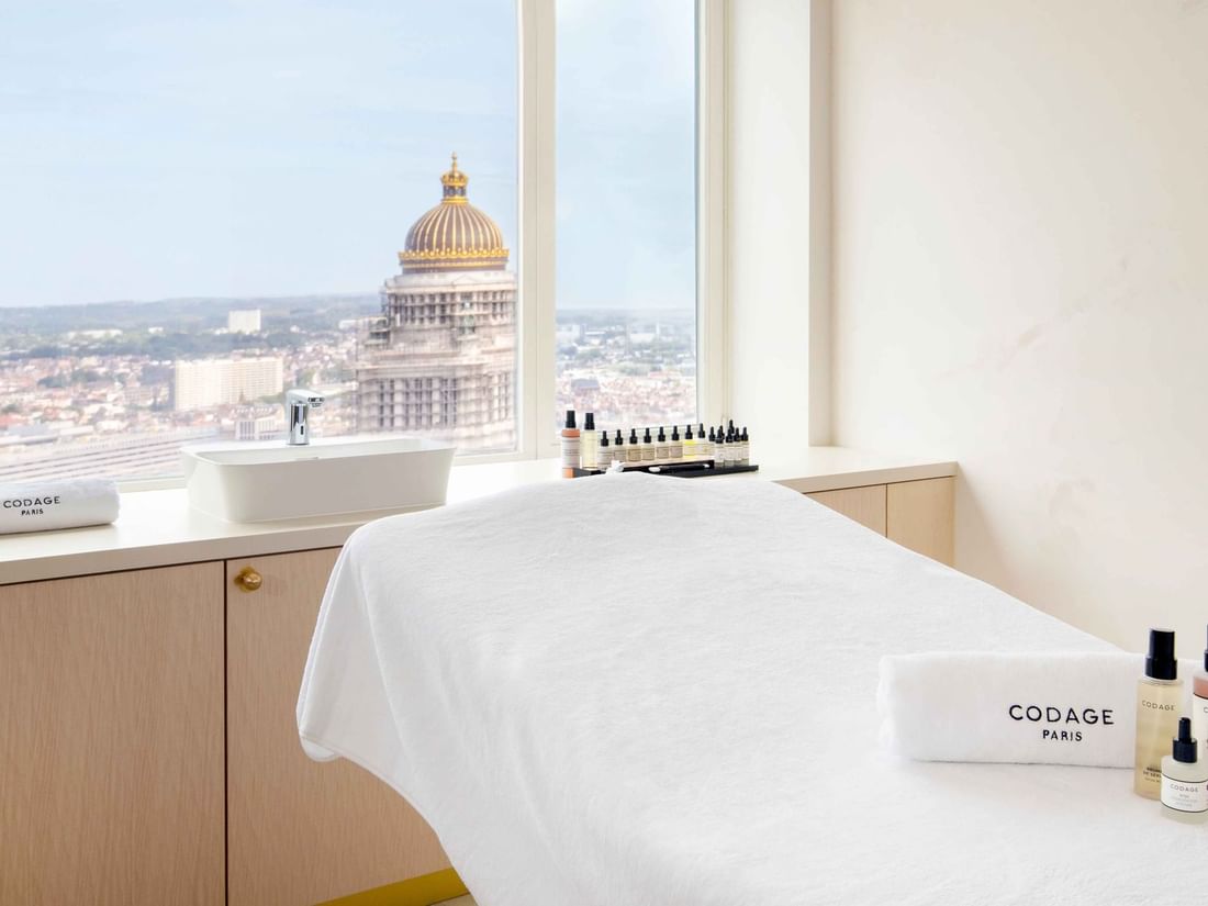 Massage table with Codage products and a beautiful view of the Palais de Justice