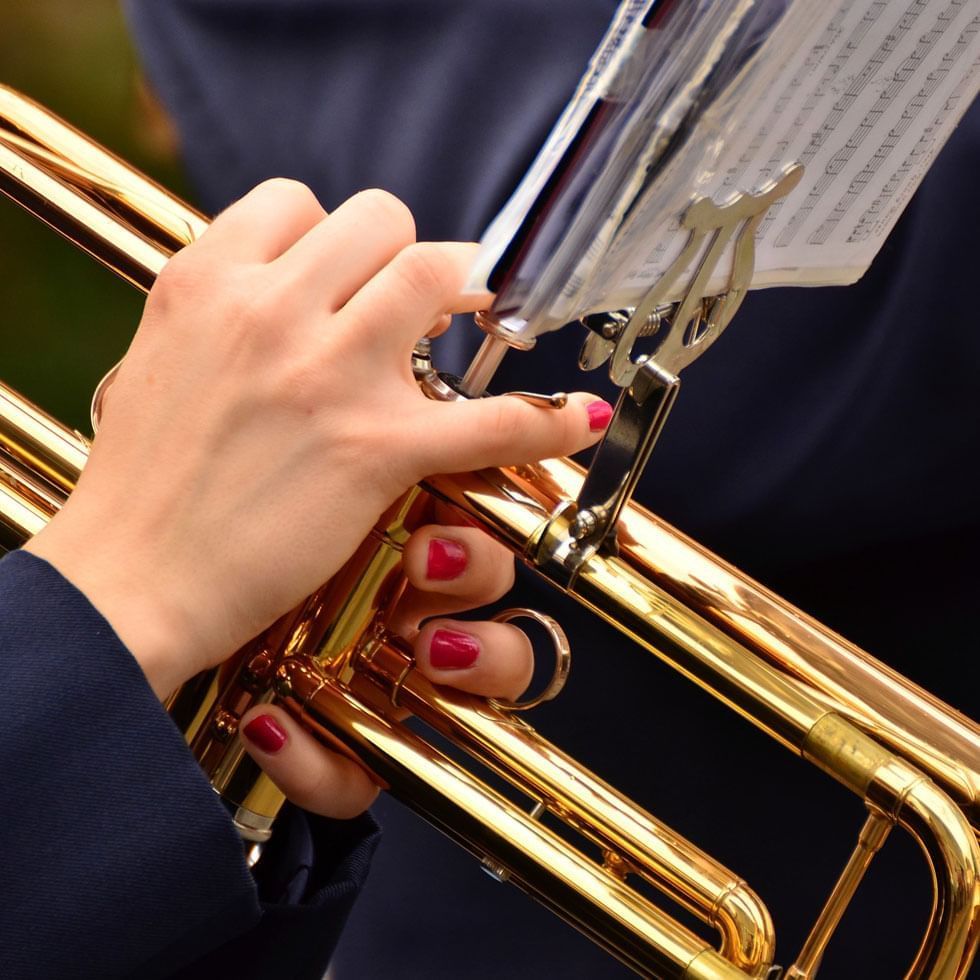 Close-up of a lady playing a trumpet at Falkensteiner Hotels