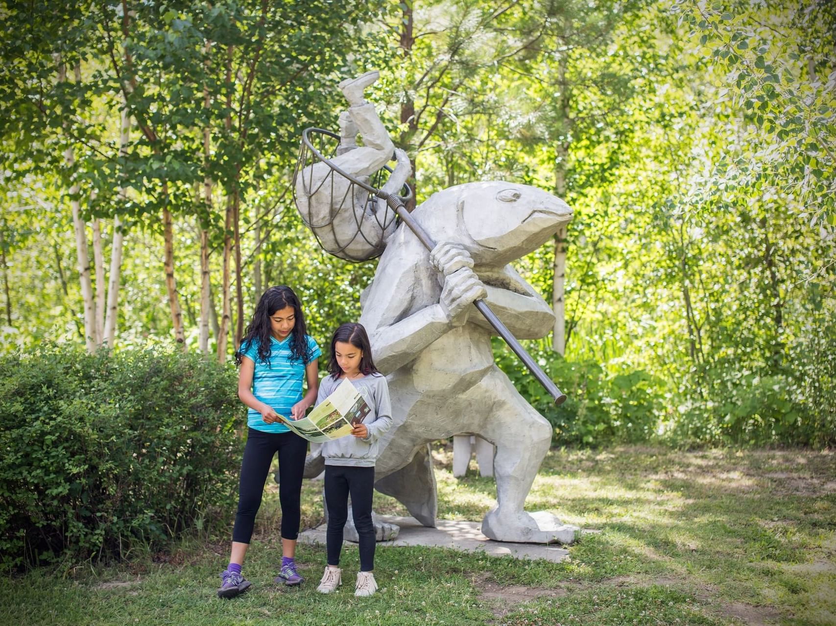 Two girls near the unique statue in the garden at Sleeping Lady