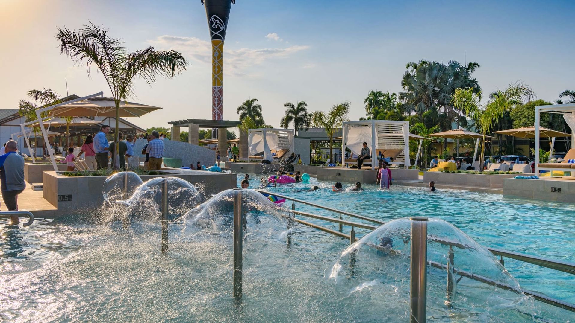 Outdoor swimming pool area with water fountains at Novotel Darwin Airport