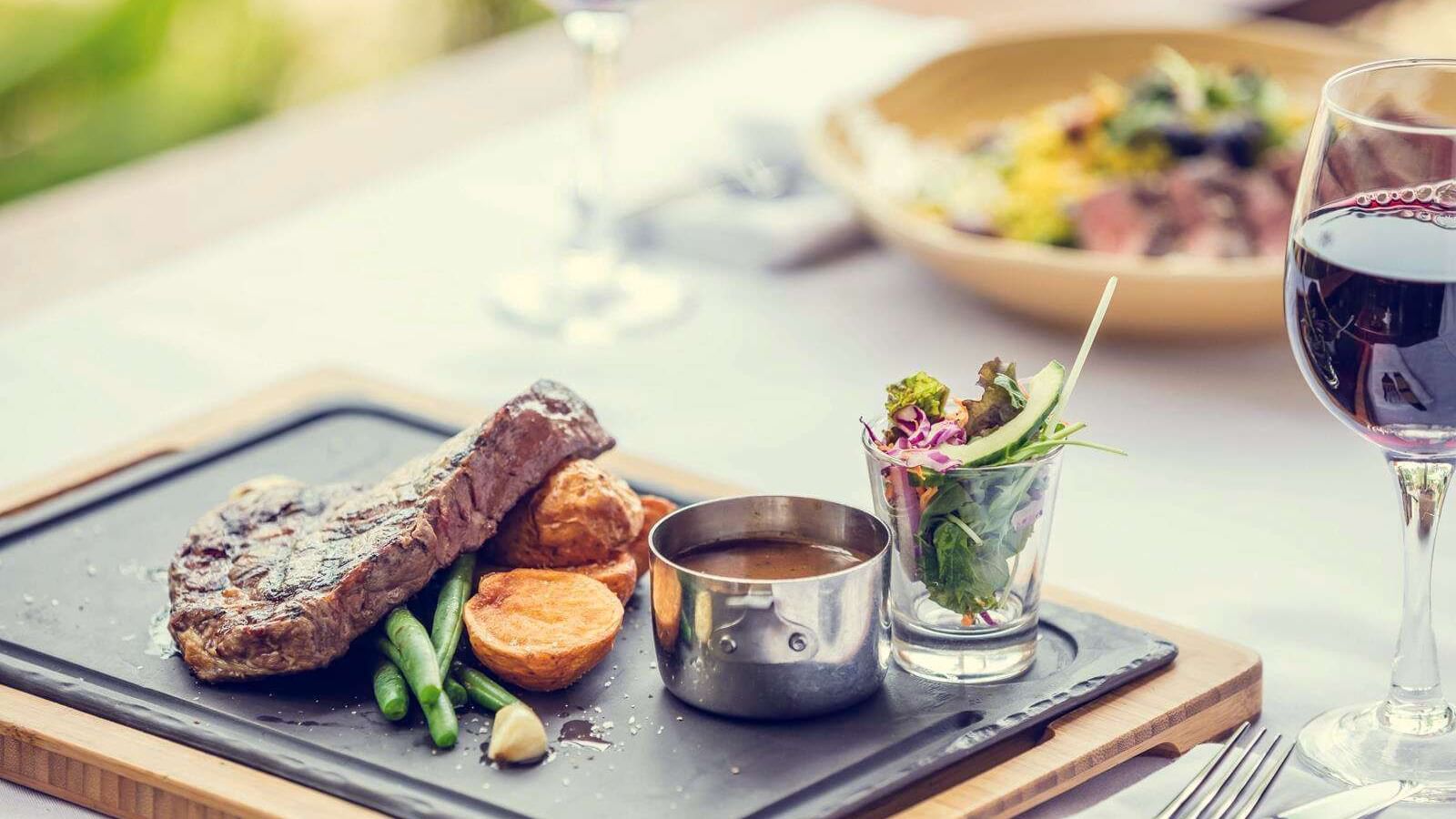 Closeup of meals served with wine at Darwin Airport Hotels