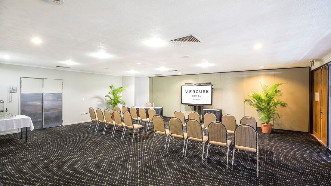 Theatre style Tinaroo Room with a presentation screen at Mercure Hotel Townsville