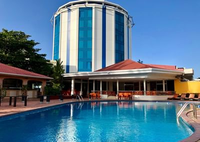 Exterior view of pool and round  building, Pegasus Hotel Guyana