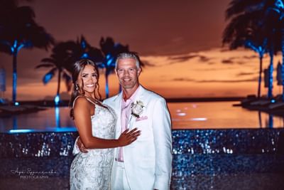 Couple posing by the pool at The Morgan Resort Spa Village