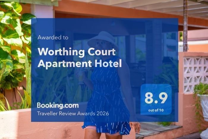 Booking. com Traveller Review Awards 2026 banner over guest at the garden walkway in Worthing Court Apartment Hotel