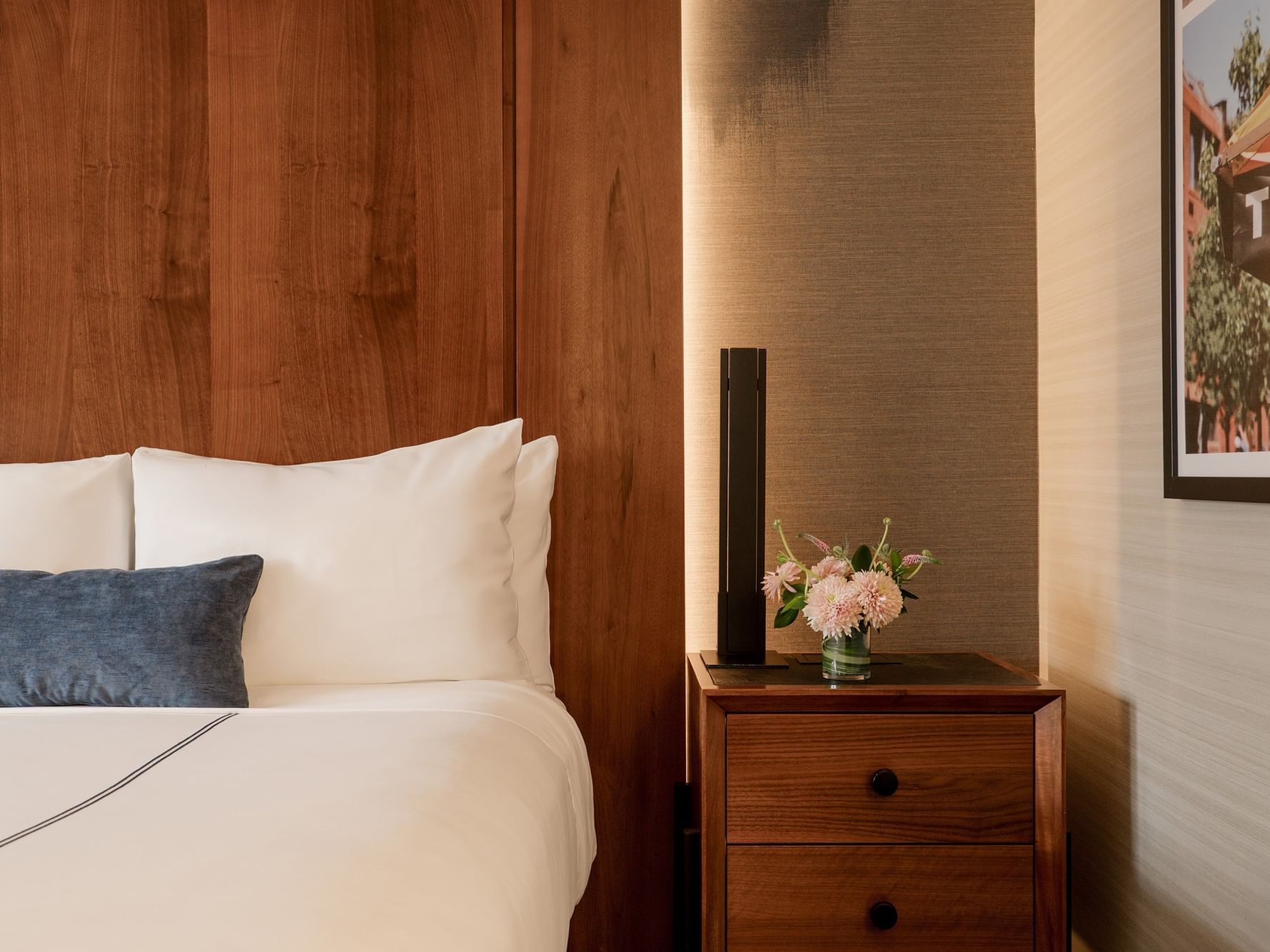 Cozy Deluxe Room with bed and flowers at Gansevoort Meatpacking NYC, New York.