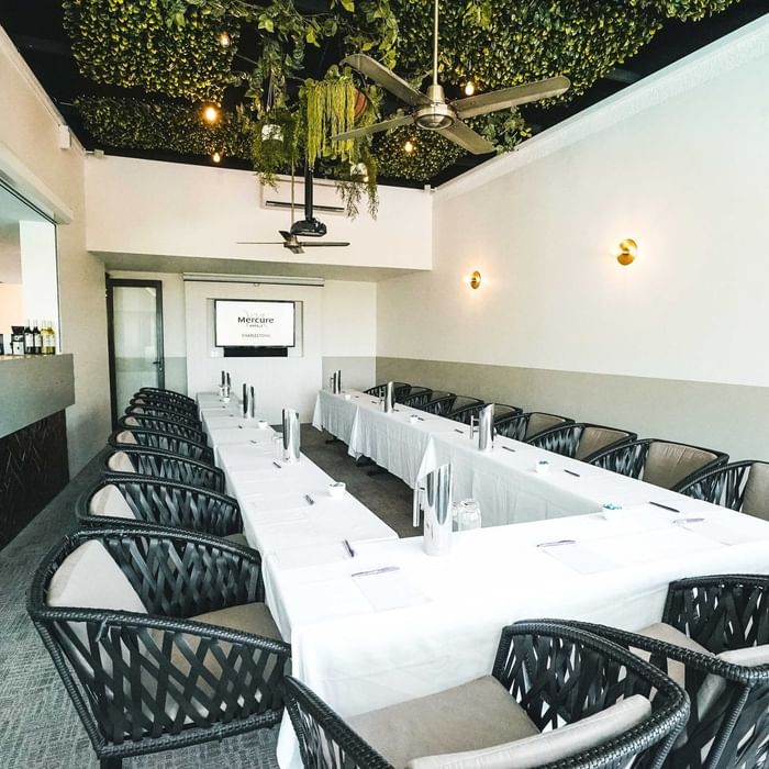 Meeting room with long tables and chairs at Mercure Charlestown.