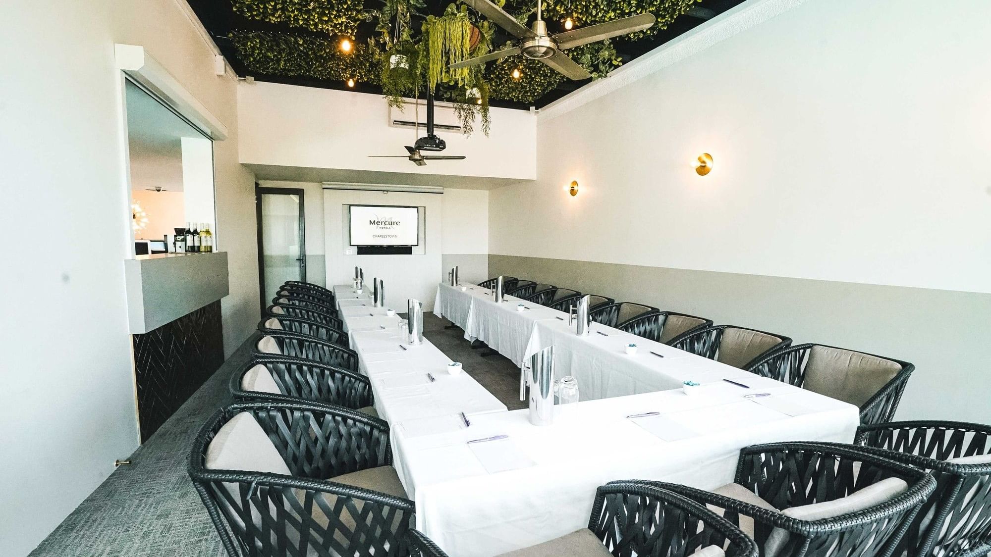 Meeting room with long tables and chairs at Mercure Charlestown.
