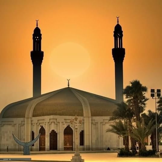 Hassan Enany Mosque with two tall minarets stands at sunset, framed by a warm orange sky near Warwick Hotel Jeddah