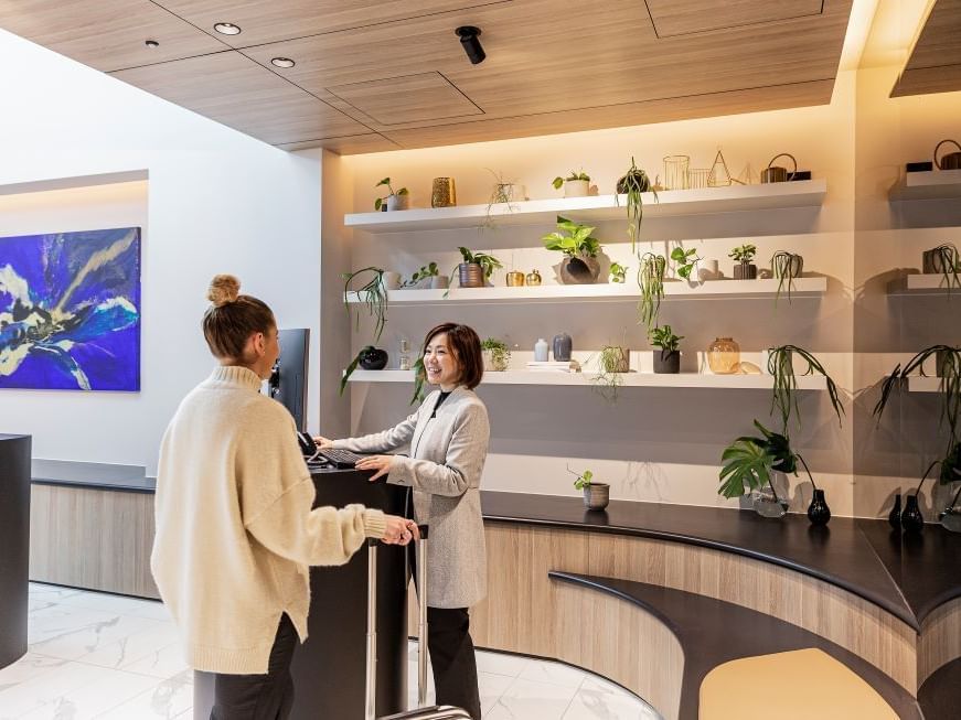 Guest talking with a receptionist at Reception of Brady Hotels Jones Lane