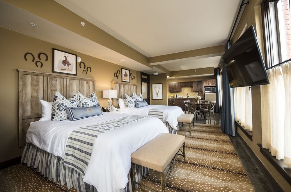 Two king beds & a TV in a room at The Frontier Hotel Pawhuska