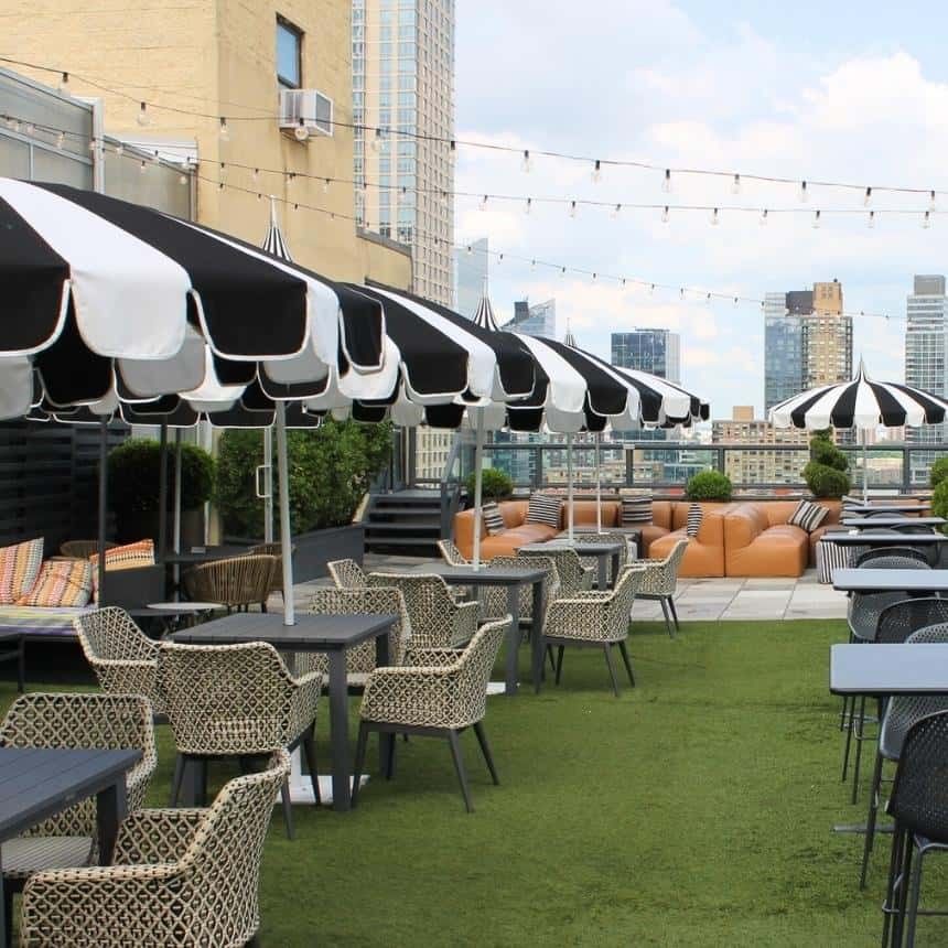 outdoor rooftop patio with umbrellas at the empire hotel