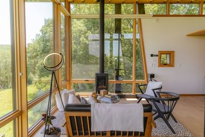 Guatemalan Coffee with windows, cozy seating, and forest views, creating a serene retreat near Singular Signature Residences