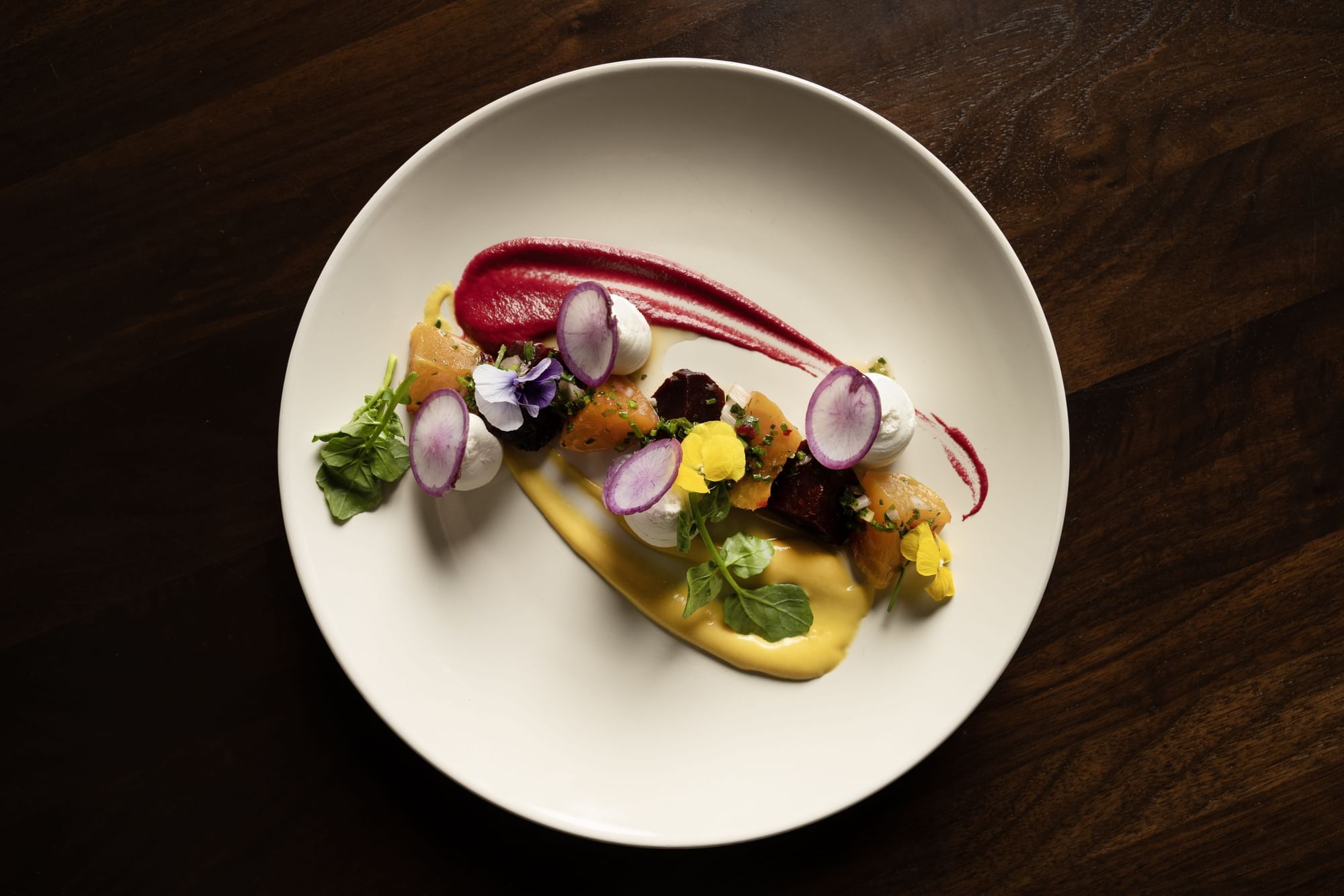 A beet salad with oven-roasted red & yellow beets, goat cheese mousse, radish, fennel, espelette pepper 
