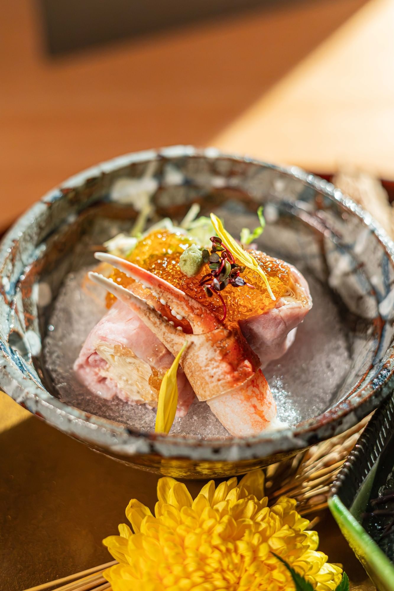 An overhead view of a traditional Japanese lacquered bowl containing fresh chirashi sushi at Hotel Okura Manila