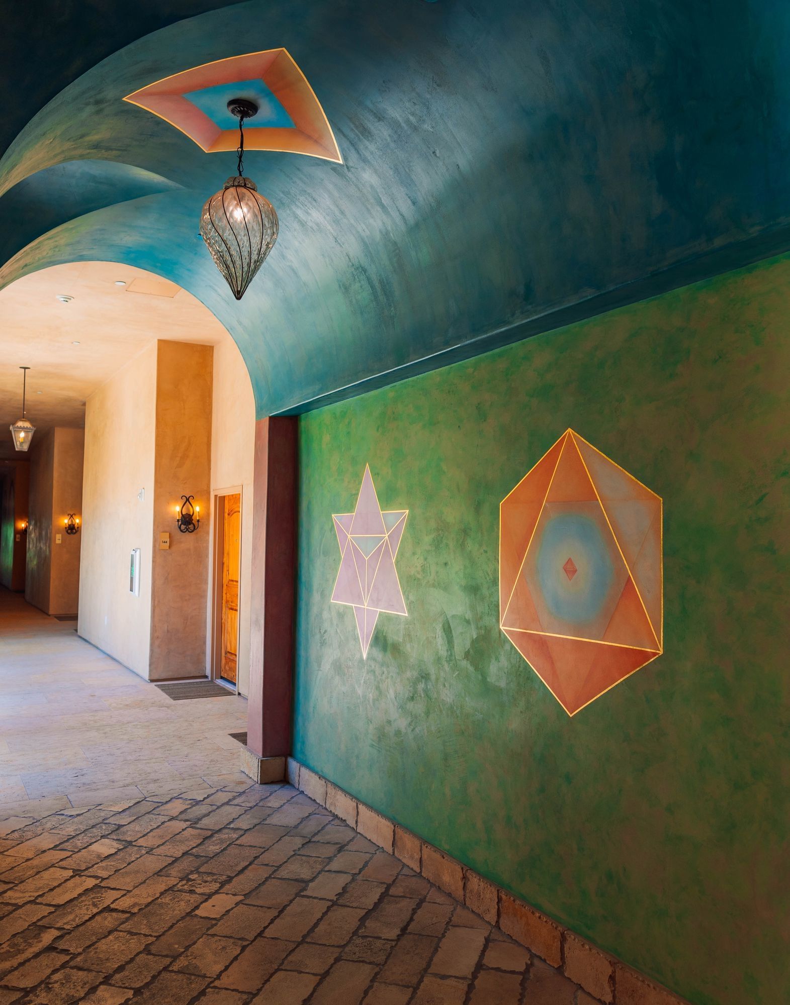 Lorem ipsum Arched hallway painted in bring orange, blue and green colors