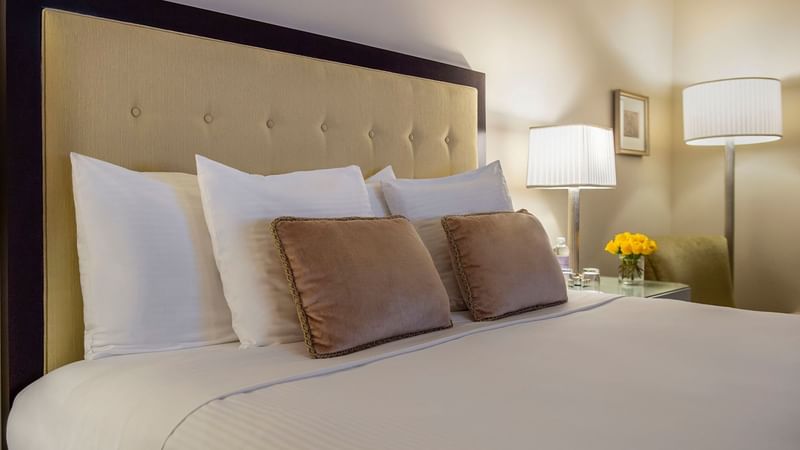 Close-up of a bed pillows and side table in Premier Room at Warwick New York