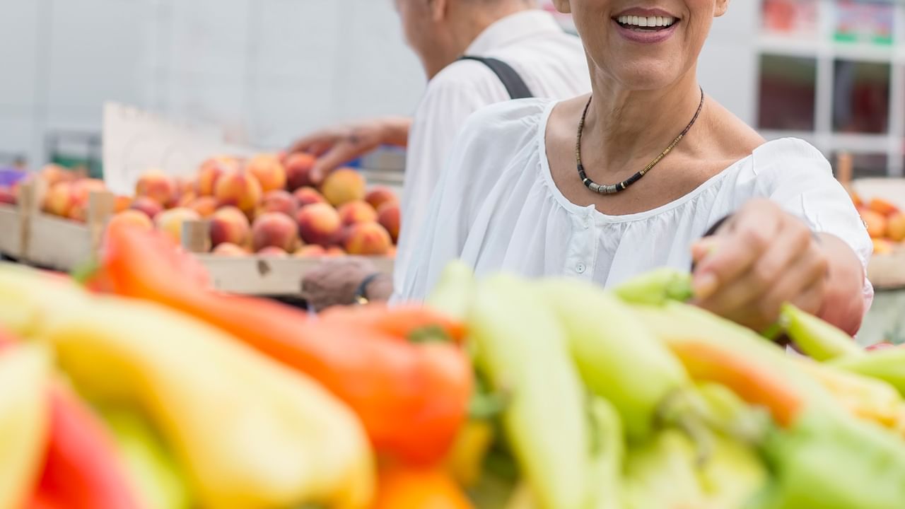 senior woman buying food at a market