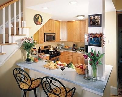 Modern kitchenette and breakfast bar with fresh flowers and snacks in a cozy room at Castle Hill Resort and Spa