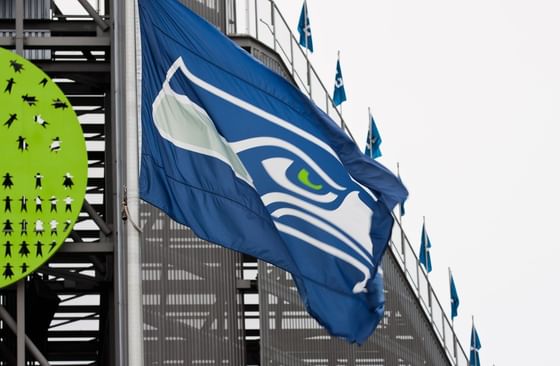 Blue sports flag by a stadium structure under a grey sky near Paramount Hotel Seattle