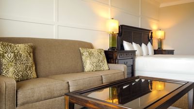 brown couch next to white bed
