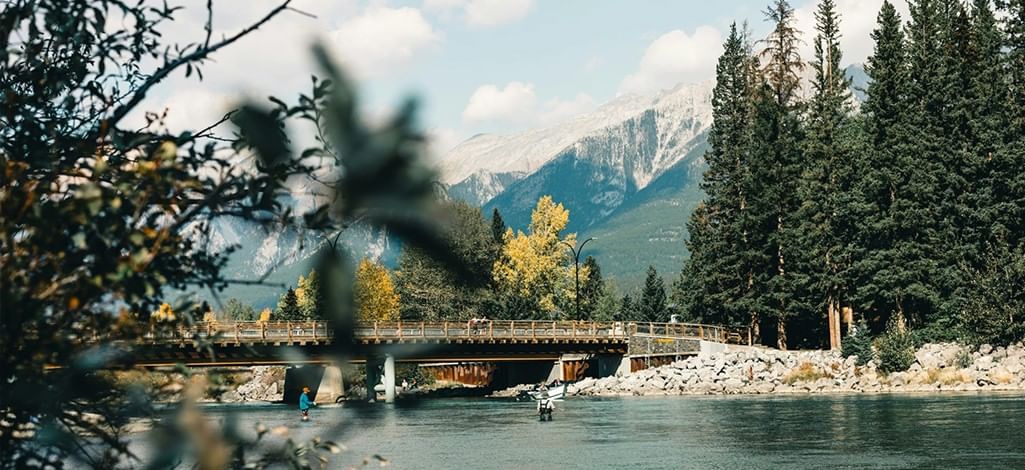 People fly fish in a lake near Canmore.