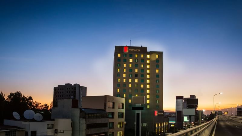 A distant view of FI Periférico Sur facade at night time