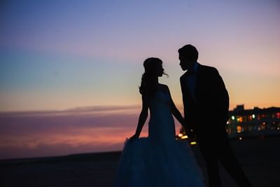 Bride and Groom on the beach at Ocean Place at sunset
